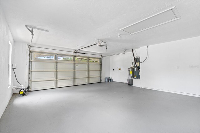 5788 Devon St, Port Orange, FL 32127 - garage featuring a garage door opener and water heater