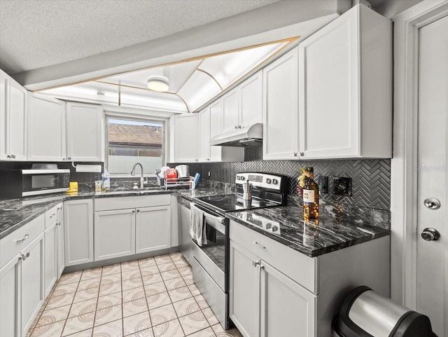 kitchen featuring appliances with stainless steel finishes, decorative backsplash, under cabinet range hood, and white cabinets