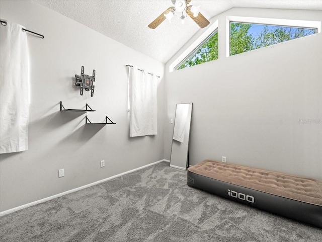 unfurnished bedroom with baseboards, carpet flooring, a ceiling fan, and vaulted ceiling