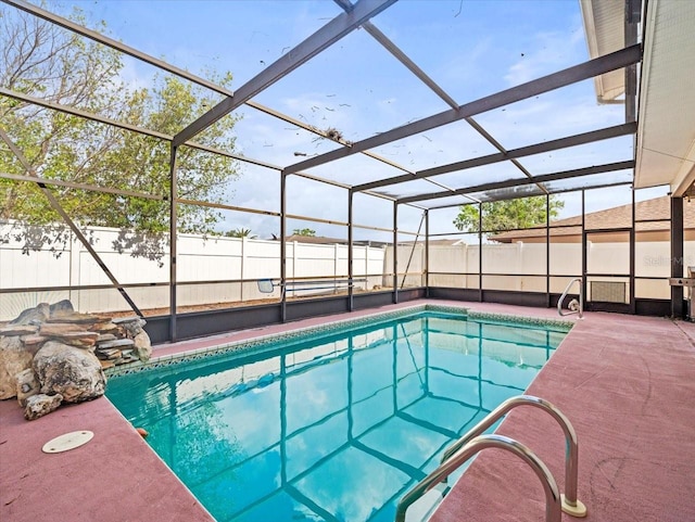 view of swimming pool featuring a fenced in pool, a lanai, a fenced backyard, and a patio area