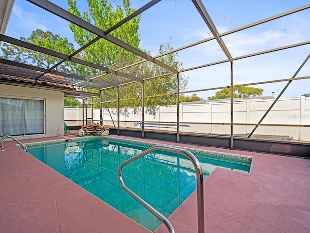 view of pool with a fenced in pool, a patio, a fenced backyard, and glass enclosure