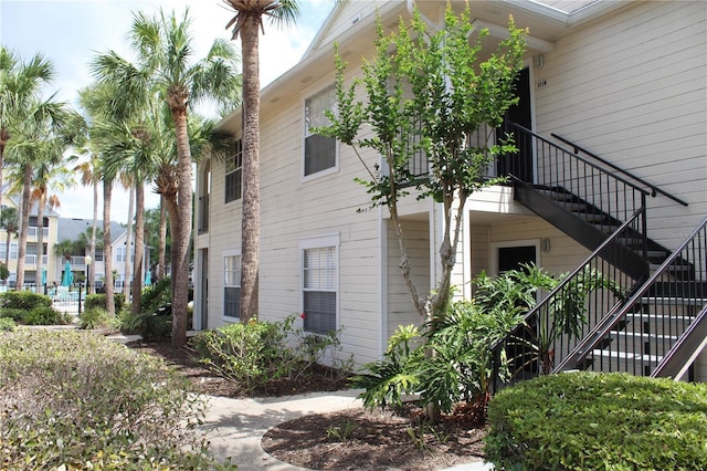 view of side of home featuring stairs
