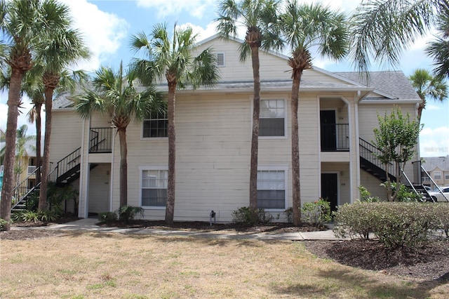 view of front of house featuring a front yard and stairway