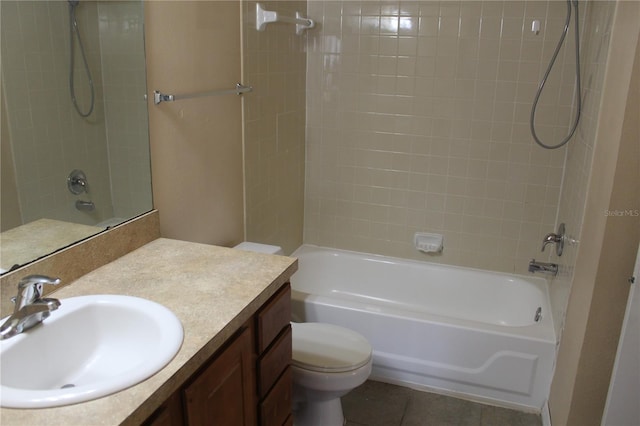 full bath featuring vanity, washtub / shower combination, tile patterned flooring, and toilet