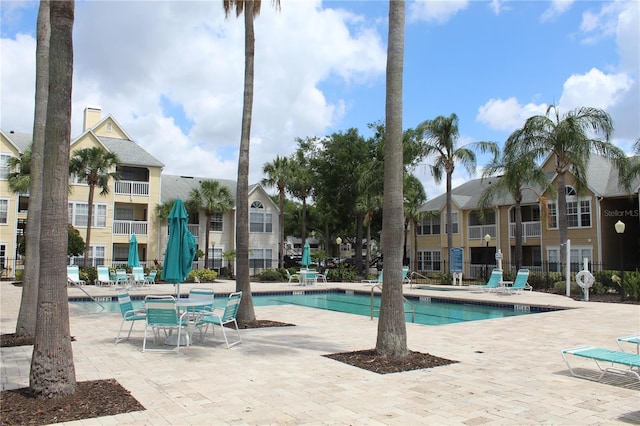 community pool featuring a patio and a residential view