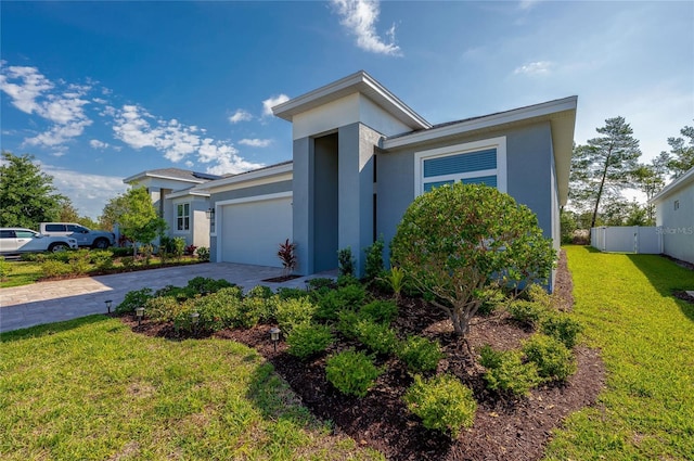 887 Lake Hill Way, Deland, FL 32724 - view of front of home featuring a garage, stucco siding, fence, a front yard, and driveway