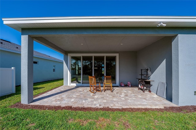 887 Lake Hill Way, Deland, FL 32724 - rear view of property featuring stucco siding, fence, and a patio