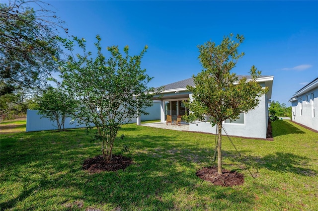 887 Lake Hill Way, Deland, FL 32724 - back of property with a lawn, a patio area, and stucco siding
