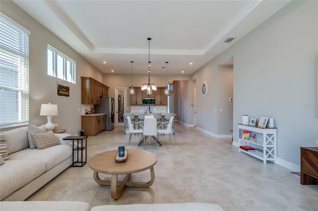 887 Lake Hill Way, Deland, FL 32724 - living area with an inviting chandelier, visible vents, baseboards, and a raised ceiling