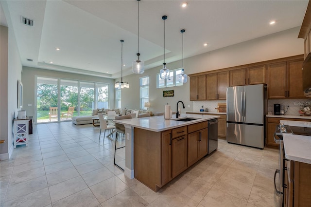 887 Lake Hill Way, Deland, FL 32724 - kitchen featuring a sink, open floor plan, visible vents, backsplash, and appliances with stainless steel finishes