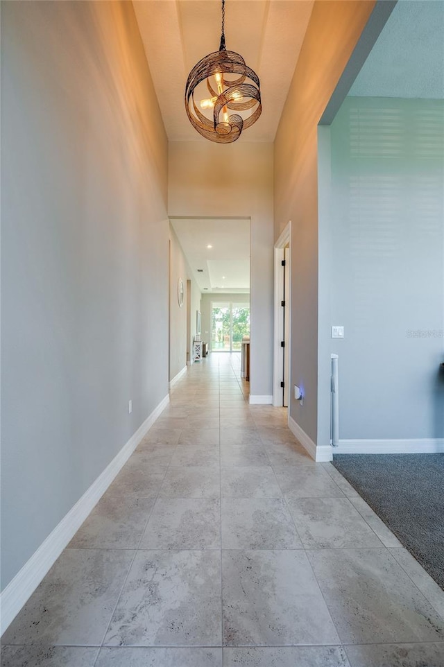 887 Lake Hill Way, Deland, FL 32724 - hallway featuring a notable chandelier and baseboards
