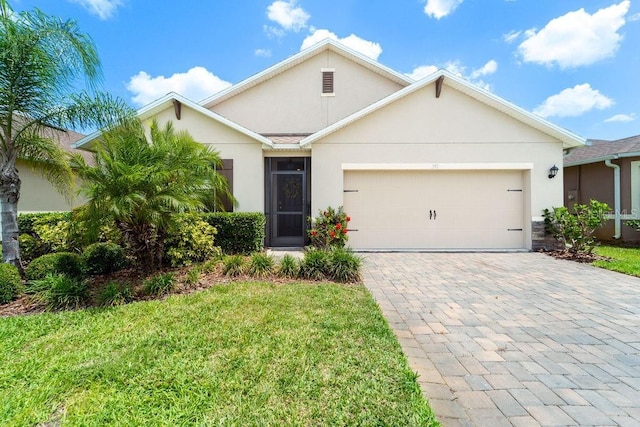 343 Lazio Cir, Debary, FL 32713 - view of front of home featuring decorative driveway, stucco siding, a garage, and a front yard
