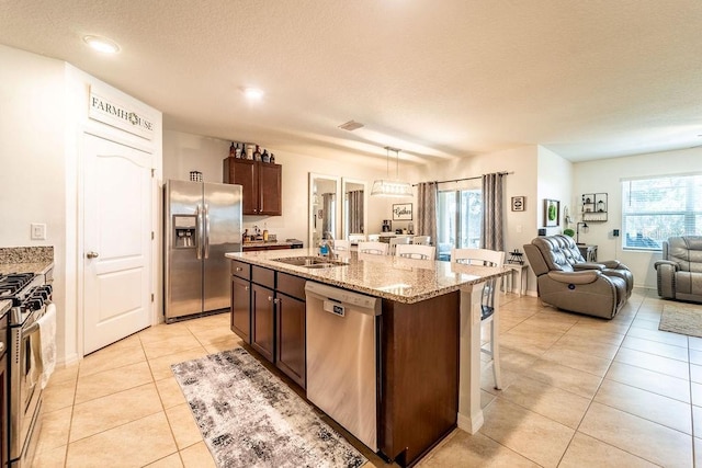 343 Lazio Cir, Debary, FL 32713 - kitchen with appliances with stainless steel finishes, a sink, a kitchen breakfast bar, open floor plan, and light tile patterned flooring