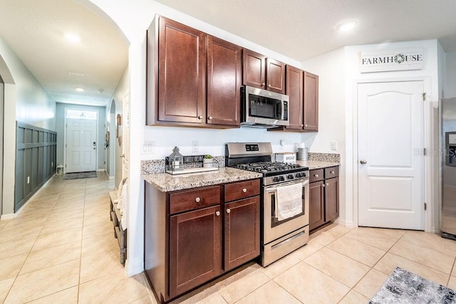343 Lazio Cir, Debary, FL 32713 - kitchen featuring appliances with stainless steel finishes, light tile patterned floors, light stone countertops, recessed lighting, and baseboards
