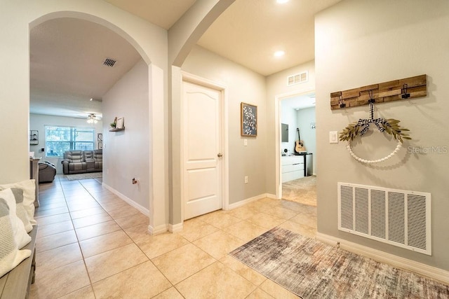 343 Lazio Cir, Debary, FL 32713 - corridor with light tile patterned floors, arched walkways, recessed lighting, and baseboards