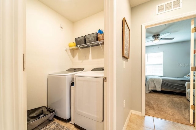 343 Lazio Cir, Debary, FL 32713 - laundry area featuring ceiling fan, independent washer and dryer, light tile patterned floors, baseboards, and light colored carpet