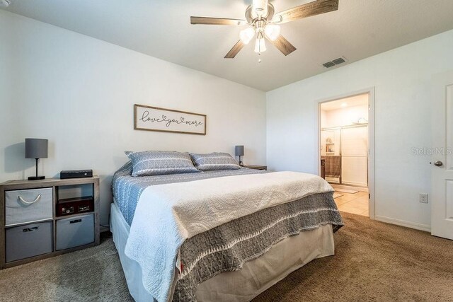 343 Lazio Cir, Debary, FL 32713 - bedroom featuring carpet flooring, baseboards, ensuite bath, and a ceiling fan