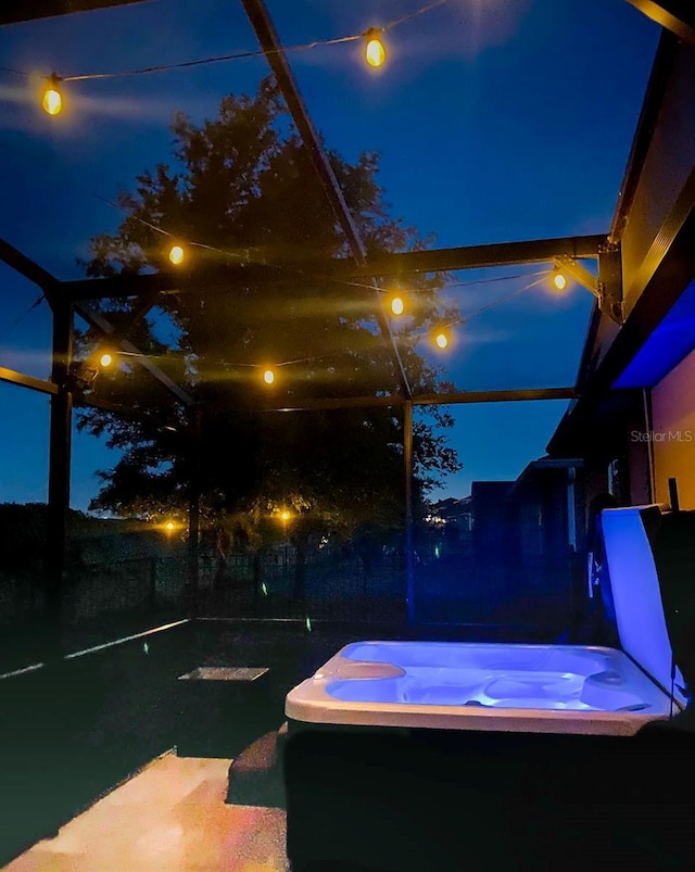 343 Lazio Cir, Debary, FL 32713 - patio at twilight with a hot tub and glass enclosure
