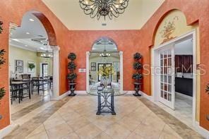 343 Lazio Cir, Debary, FL 32713 - entrance foyer featuring a chandelier, french doors, arched walkways, and baseboards