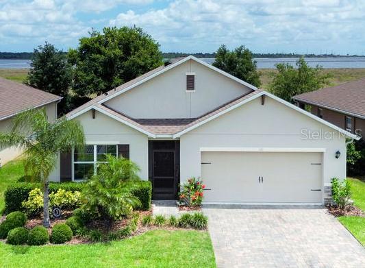 343 Lazio Cir, Debary, FL 32713 - view of front of home featuring a garage, driveway, and stucco siding