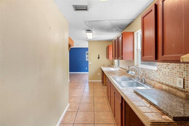 1560 7th Ave, Deland, FL 32724 - kitchen featuring a sink, backsplash, baseboards, light tile patterned flooring, and a textured ceiling