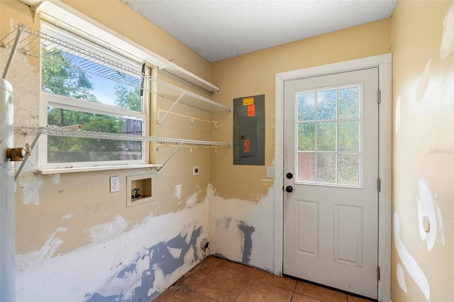 1560 7th Ave, Deland, FL 32724 - clothes washing area with electric panel, electric dryer hookup, tile patterned flooring, hookup for a washing machine, and a textured ceiling