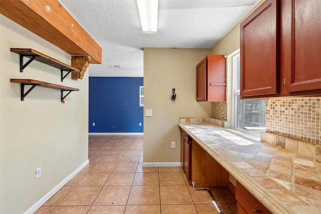 1560 7th Ave, Deland, FL 32724 - kitchen featuring open shelves, tasteful backsplash, tile countertops, light tile patterned floors, and baseboards