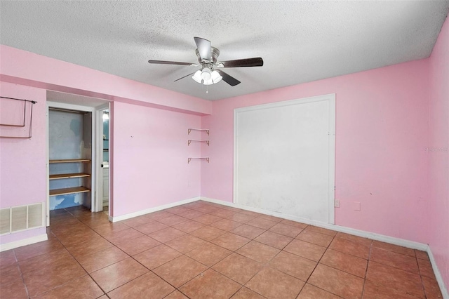 1560 7th Ave, Deland, FL 32724 - spare room with ceiling fan, a textured ceiling, light tile patterned flooring, and baseboards