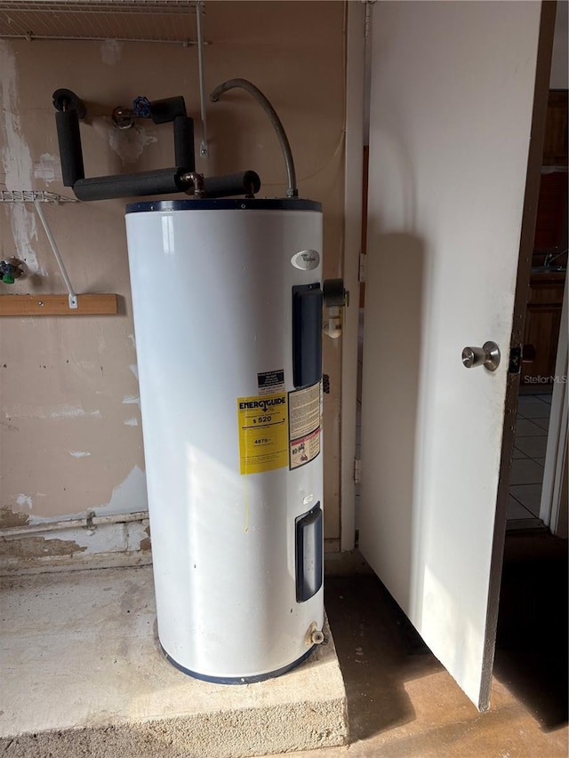 utility room featuring water heater