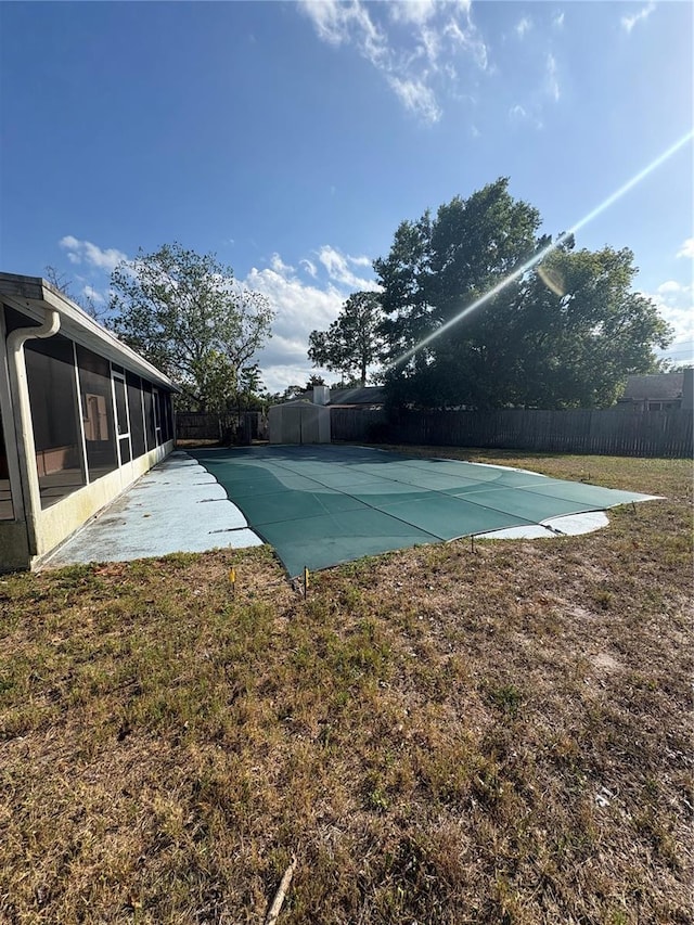 view of pool with a sunroom and a patio
