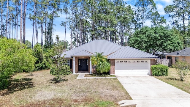 ranch-style house with a standing seam roof, metal roof, brick siding, concrete driveway, and an attached garage