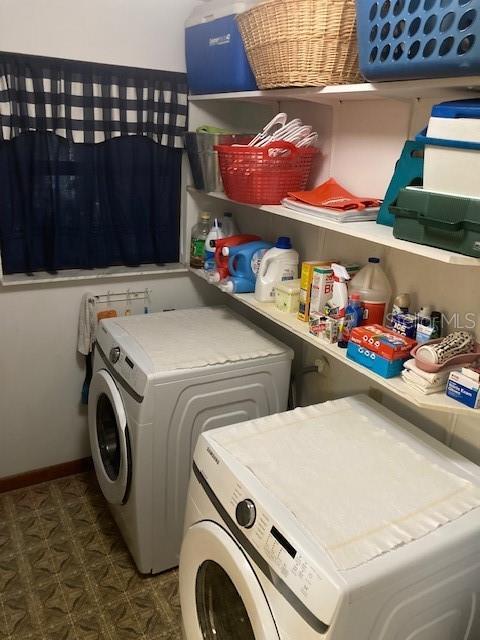 laundry area with independent washer and dryer, laundry area, baseboards, and tile patterned floors