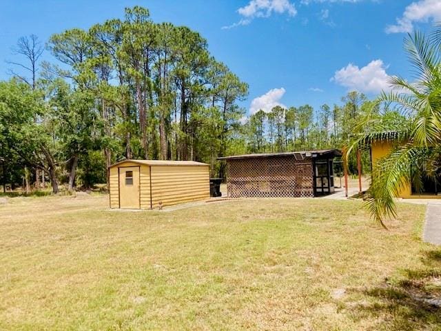 view of yard with a storage shed and an outbuilding