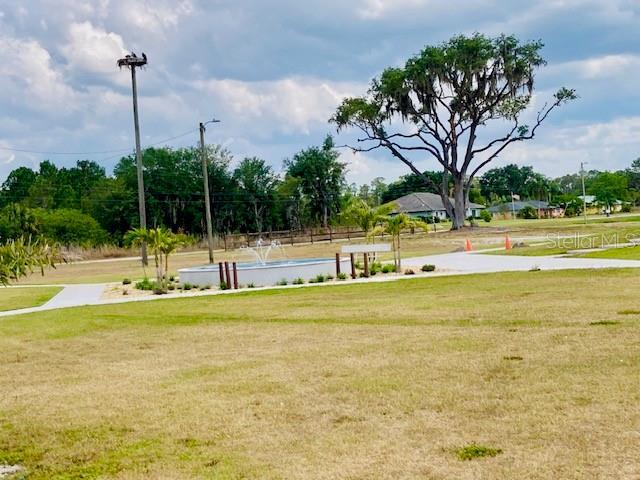 view of home's community featuring a lawn