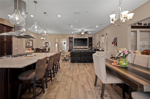 dining area featuring visible vents, recessed lighting, light wood finished floors, and ceiling fan with notable chandelier