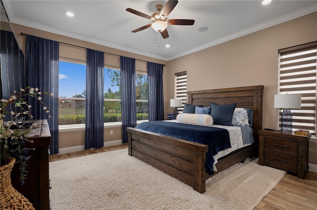 bedroom featuring baseboards, ornamental molding, recessed lighting, and wood finished floors