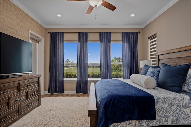 bedroom with baseboards, ornamental molding, ceiling fan, and wood finished floors