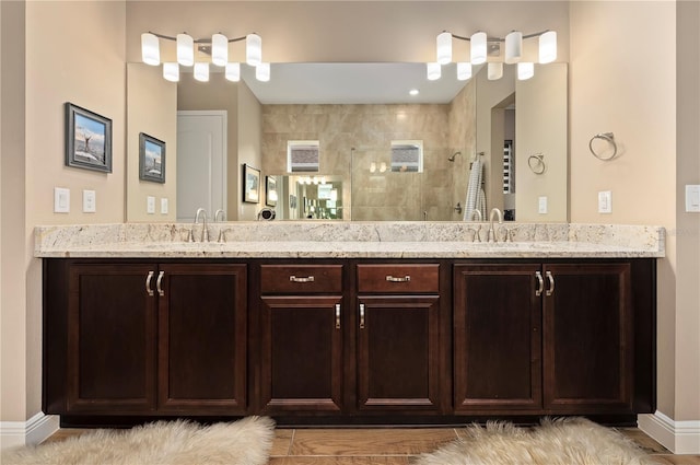 full bathroom with a sink, a walk in shower, and double vanity