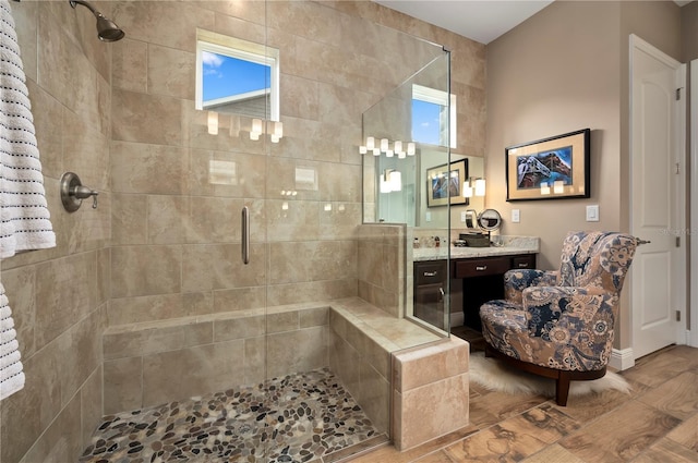bathroom with vanity, a stall shower, and wood finished floors