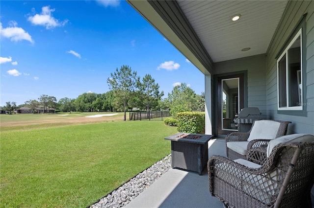 exterior space featuring view of golf course and a fire pit