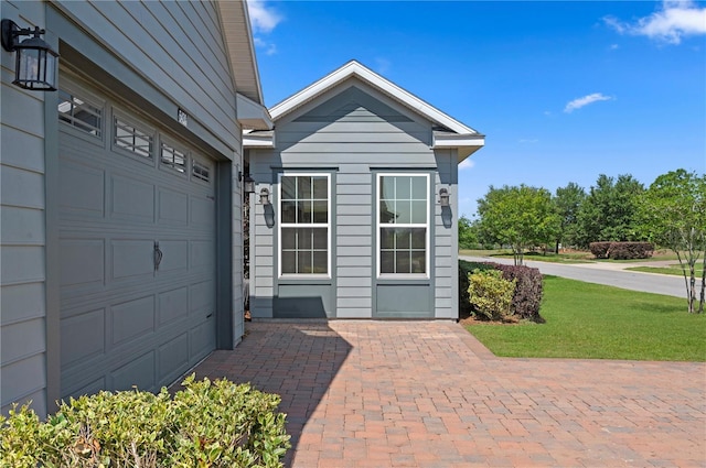 exterior space featuring a lawn and a garage