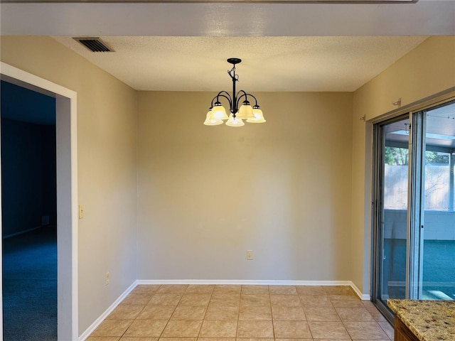 unfurnished dining area featuring light tile patterned flooring, a textured ceiling, a chandelier, and visible vents