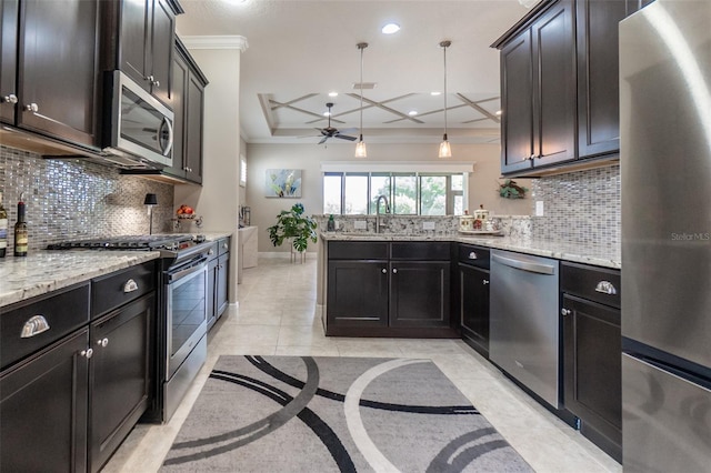 kitchen featuring ceiling fan, a sink, a peninsula, crown molding, and appliances with stainless steel finishes