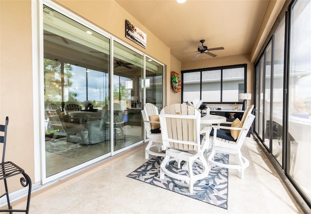 sunroom featuring ceiling fan