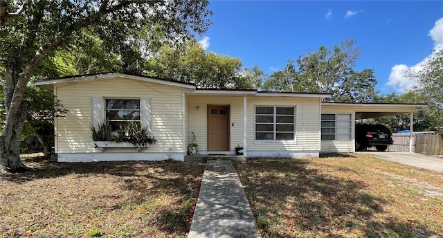 2332 Hadley St, Deltona, FL 32738 - view of front facade featuring concrete driveway, a carport, and fence
