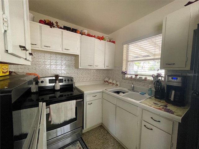 2332 Hadley St, Deltona, FL 32738 - kitchen featuring stainless steel electric range, a sink, light countertops, and white cabinetry