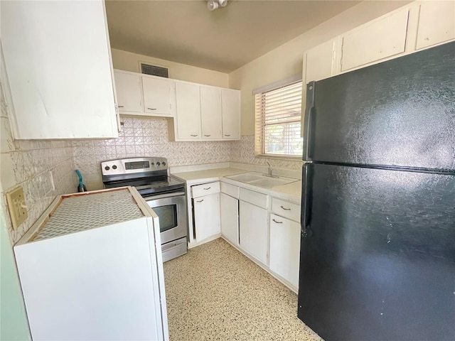 2332 Hadley St, Deltona, FL 32738 - kitchen featuring freestanding refrigerator, electric stove, a sink, backsplash, and white cabinetry