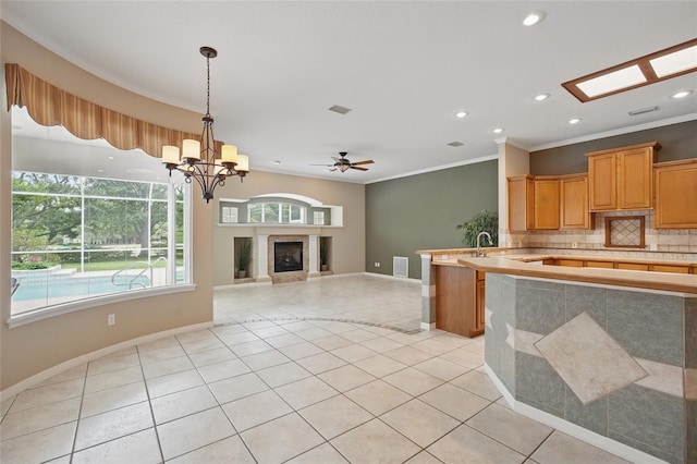 1641 Timber Hills Dr, Deland, FL 32724 - kitchen featuring light countertops, tasteful backsplash, light tile patterned flooring, recessed lighting, and baseboards