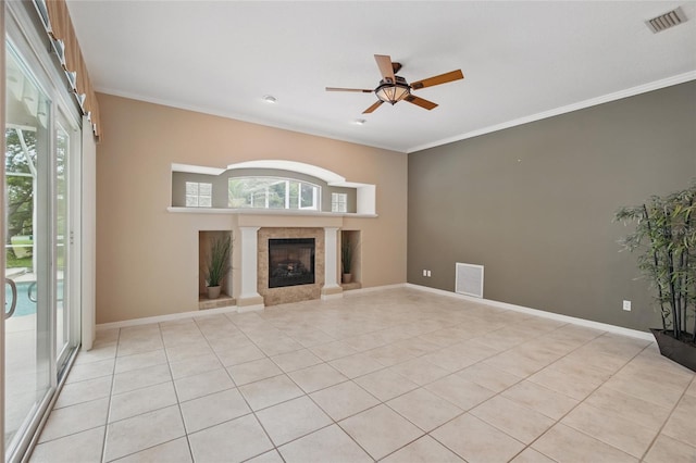1641 Timber Hills Dr, Deland, FL 32724 - unfurnished living room featuring a tiled fireplace, ceiling fan, light tile patterned flooring, crown molding, and baseboards