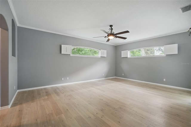 1641 Timber Hills Dr, Deland, FL 32724 - spare room with crown molding, ceiling fan, light wood-type flooring, baseboards, and arched walkways
